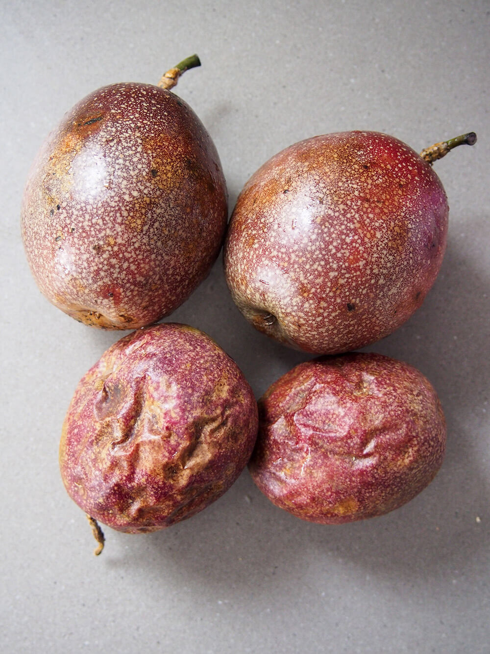 4 passion fruit - some with wrinkles, other smooth