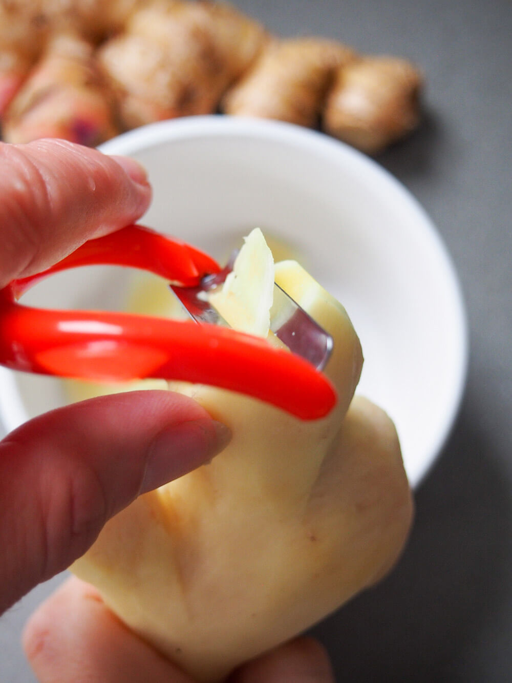 peeling slices of ginger