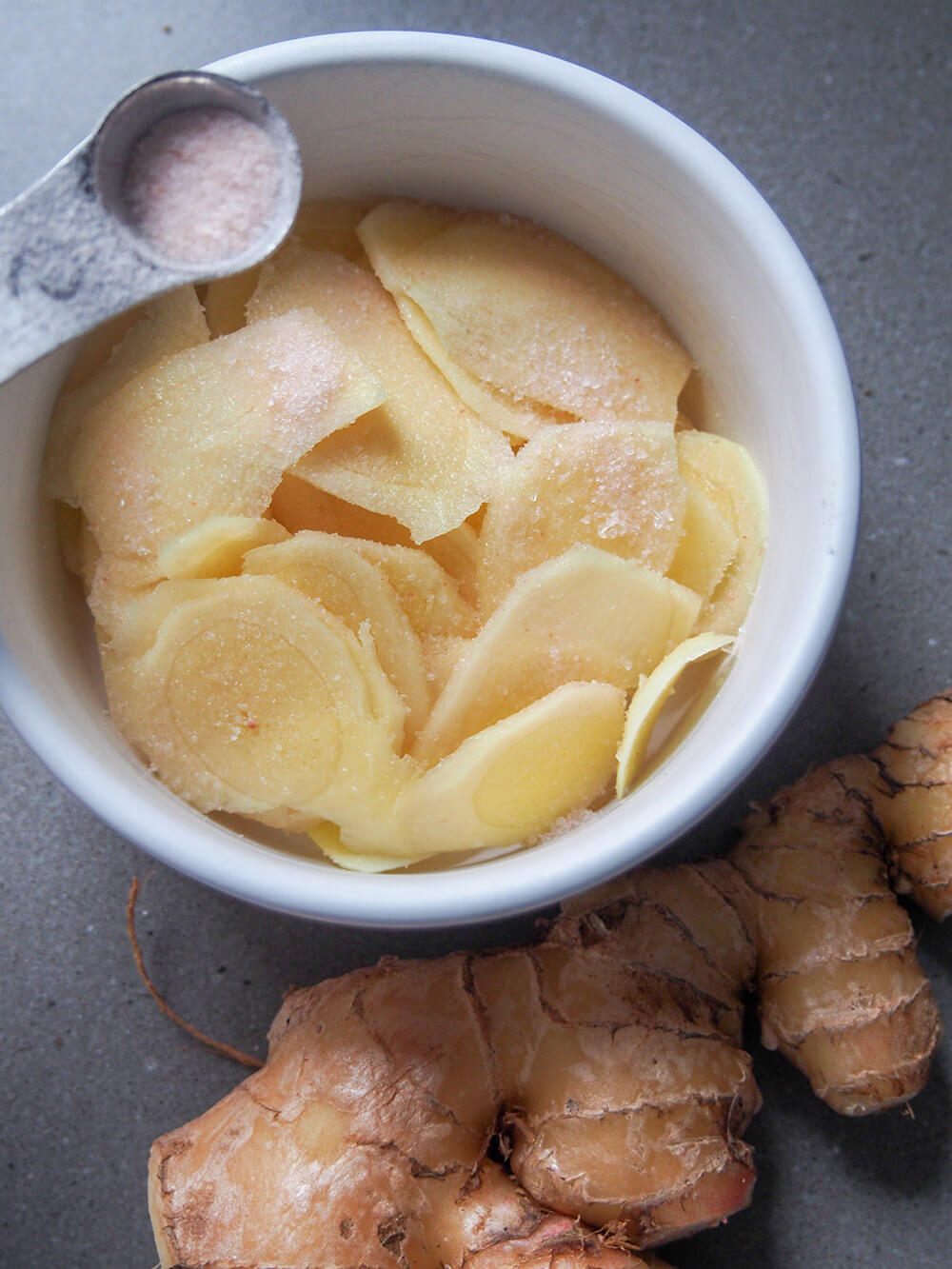 salting slices of ginger before boiling and pickling