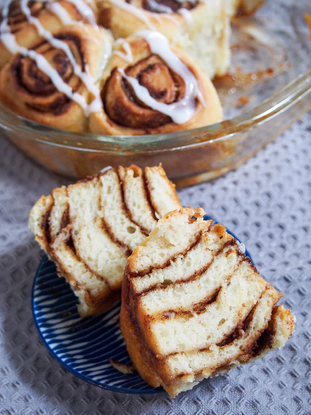 Give your starter a different use in these fluffy sourdough cinnamon rolls. They are packed with delicious flavor and have a wonderful texture. Prepare the night before or the same day as suits. A sourdough cinnamon roll cut in half so that you can see the lines of the cinnamon filling in the dough