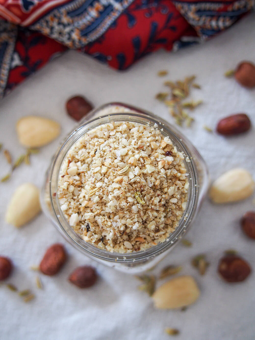 Dukkah is an Egyptian blend of nuts and spices that is easy to make and adds a wonderful crunch and flavor to so many things. A tasty addition to everything from eggs to salads. overhead shot of dukkah in jar