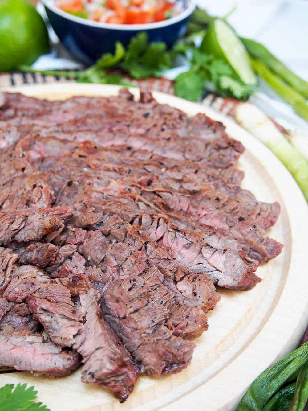 sliced up carne asada on cutting board