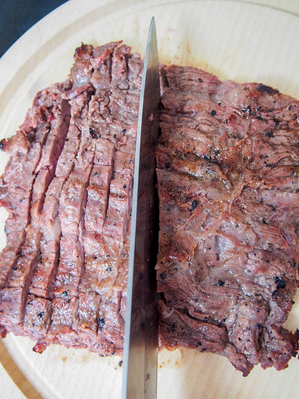 slicing cooked meat across the grain