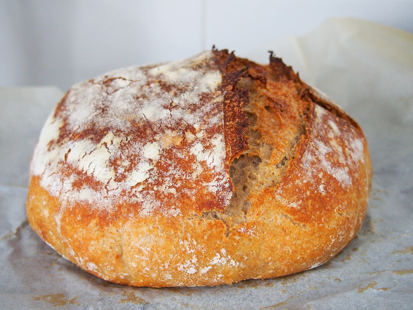 loaf of pain de campagne (French country bread) cooling on parchment