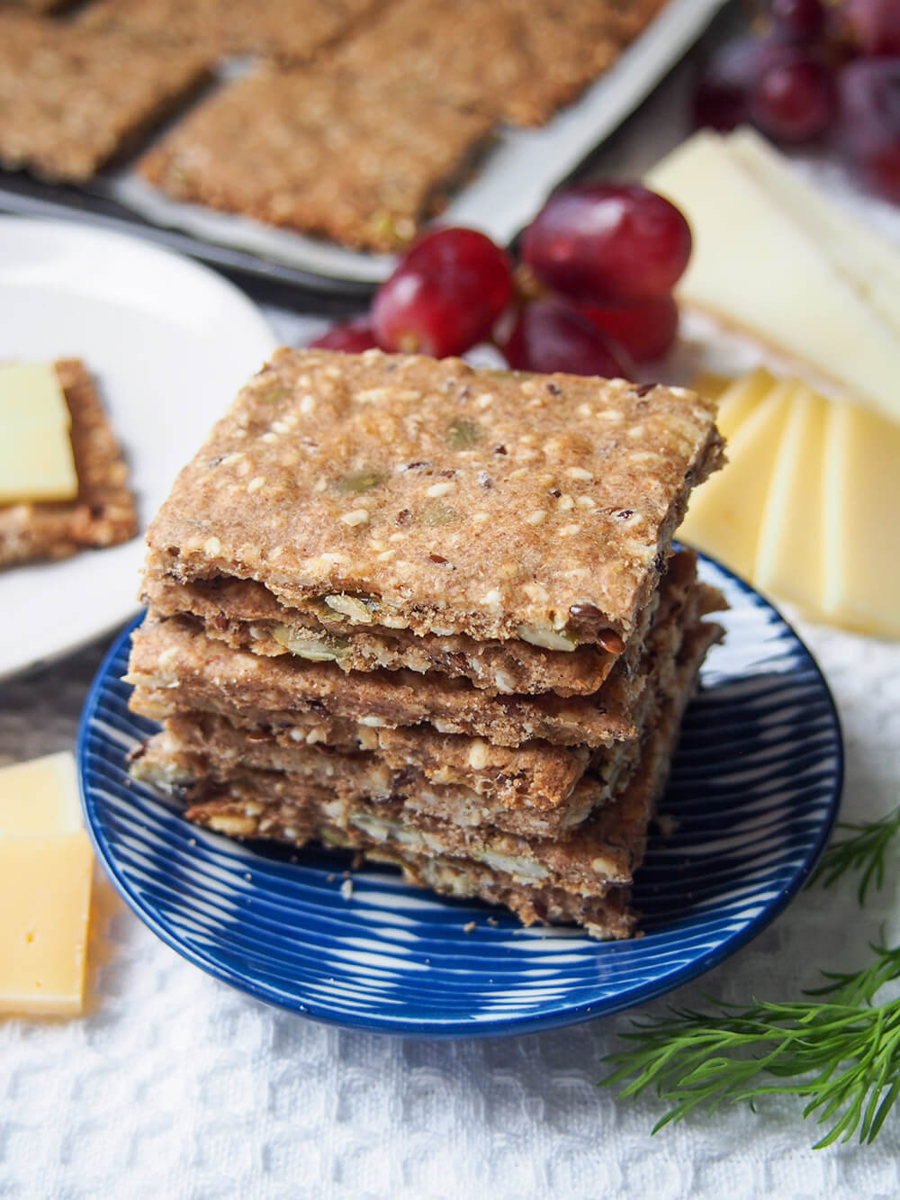 plate with Swedish crispbread stack (rye seed crackers) with more behind