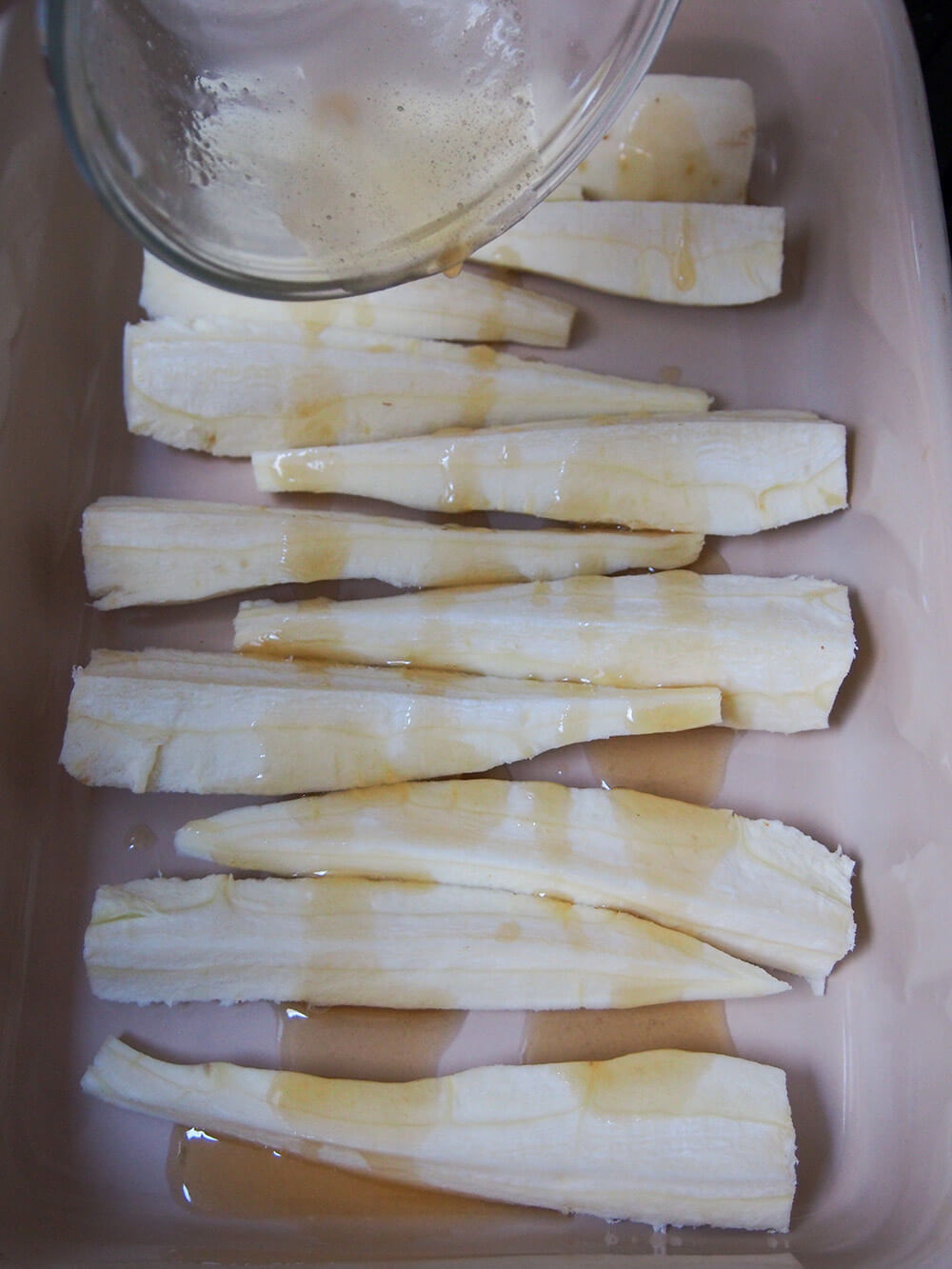 drizzling maple butter over parsnips