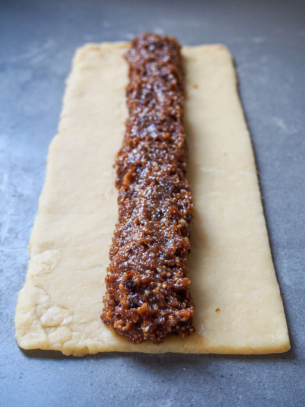 log of filling on rectangle of pastry before rolling up
