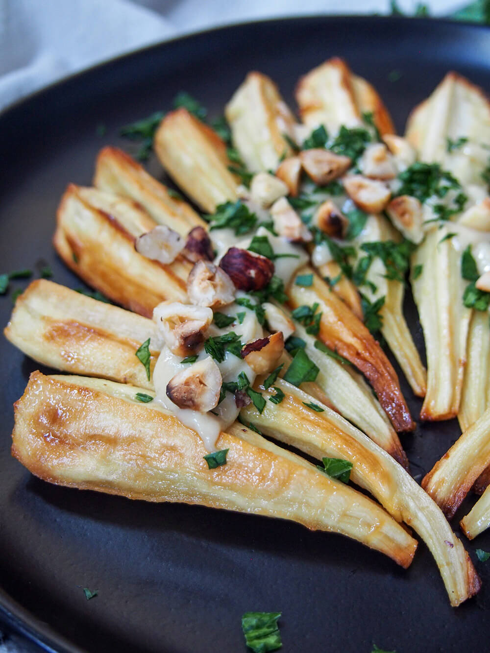 side view of maple roasted parsnips on plate