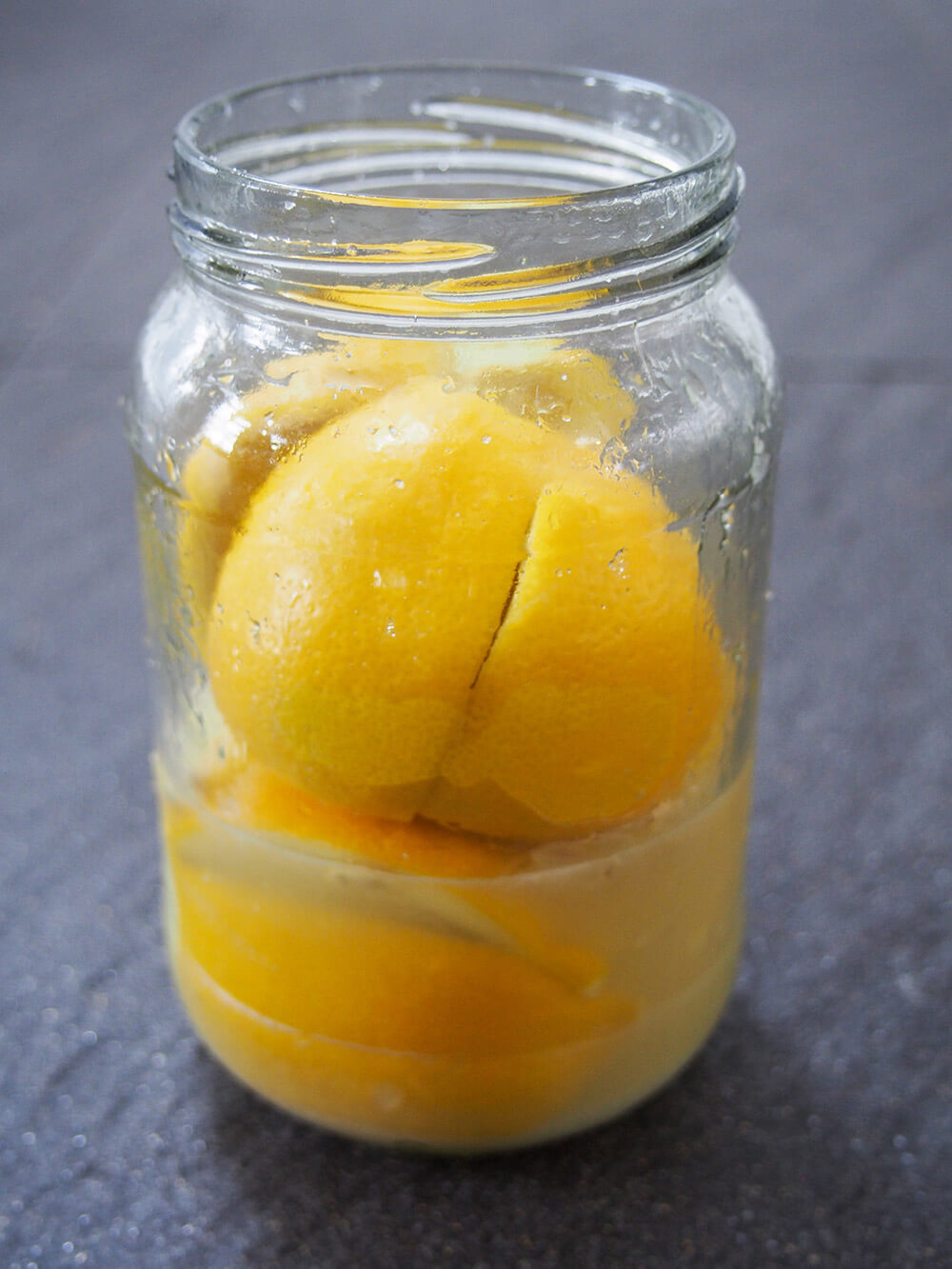part-filled jar with lemons and some juice