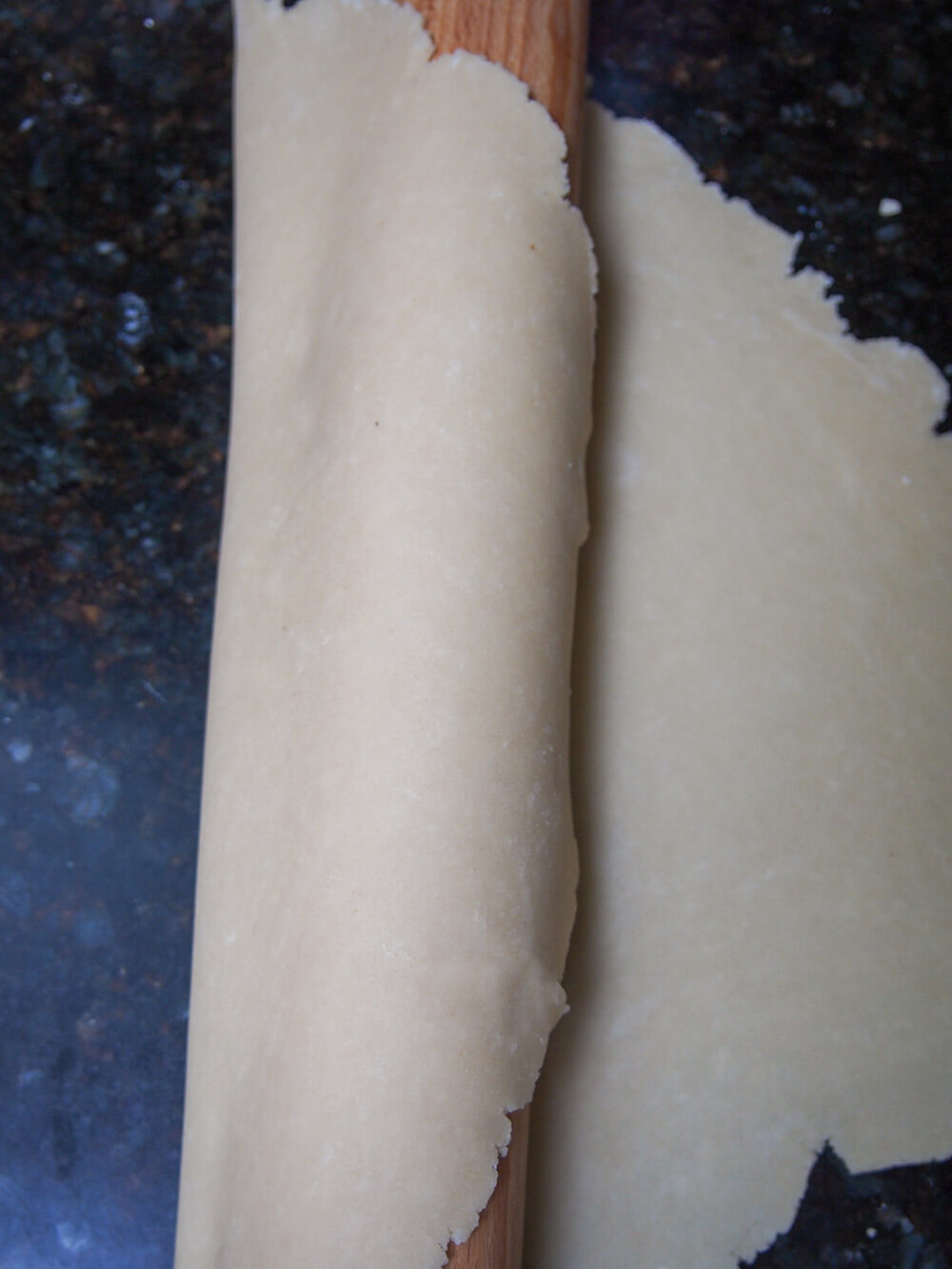 using rolling pin to pick up pastry