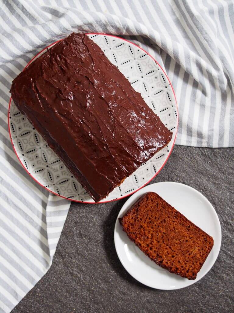 loaf of piernik from overhead with slice on small plate to side