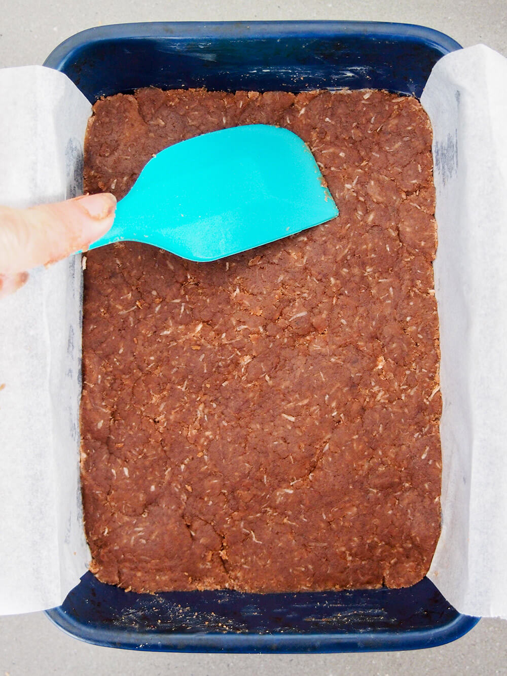 pressing base into dish before baking