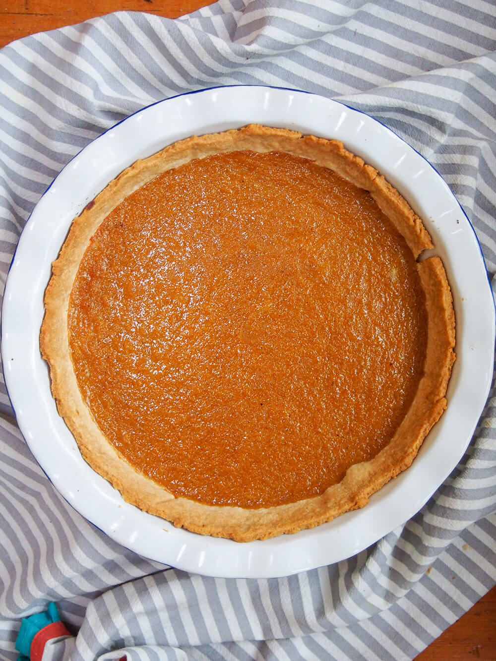 whole pumpkin pie in pie dish viewed from overhead