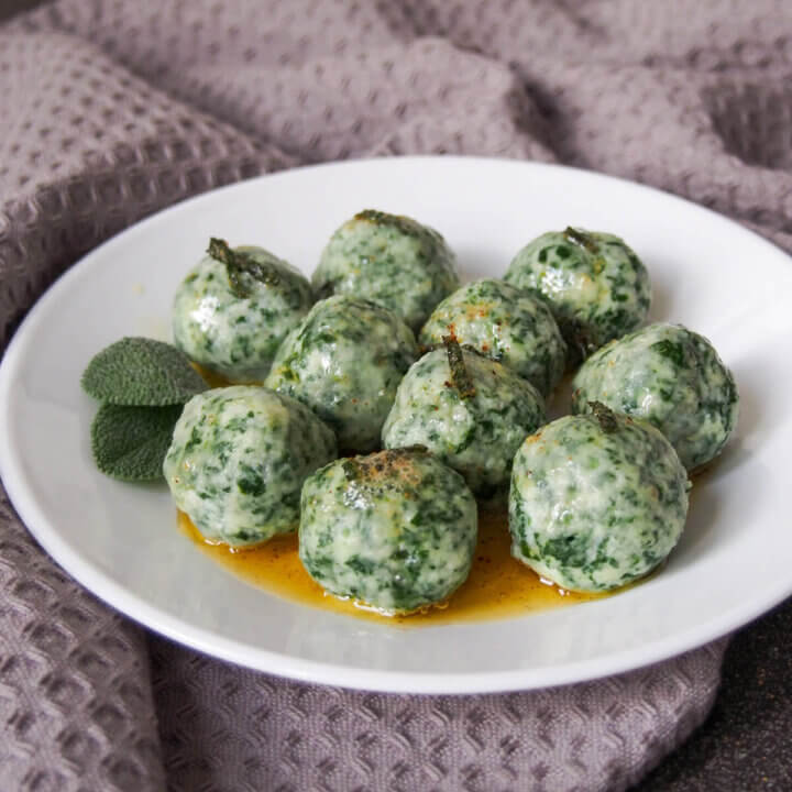 Ricotta and spinach gnudi on plate with sage browned butter