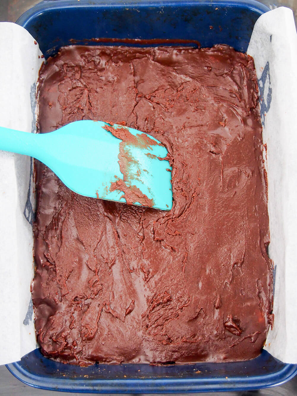 spreading frosting over baked base