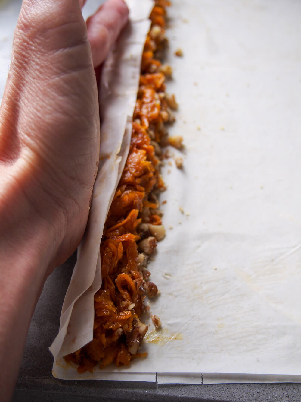 starting to roll pastry around pumpkin filling