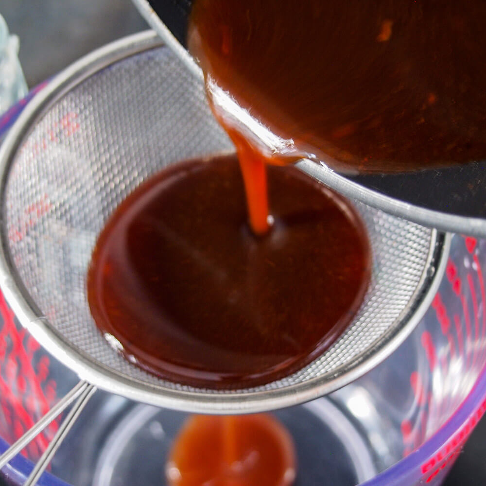 straining pumpkin spice syrup