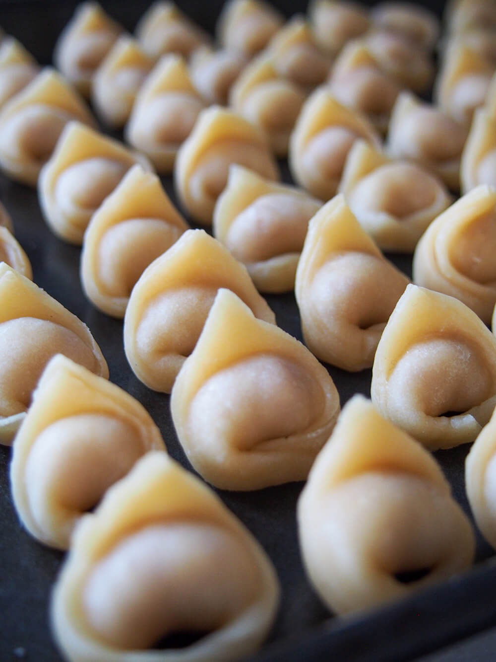 formed tortellini on baking sheet