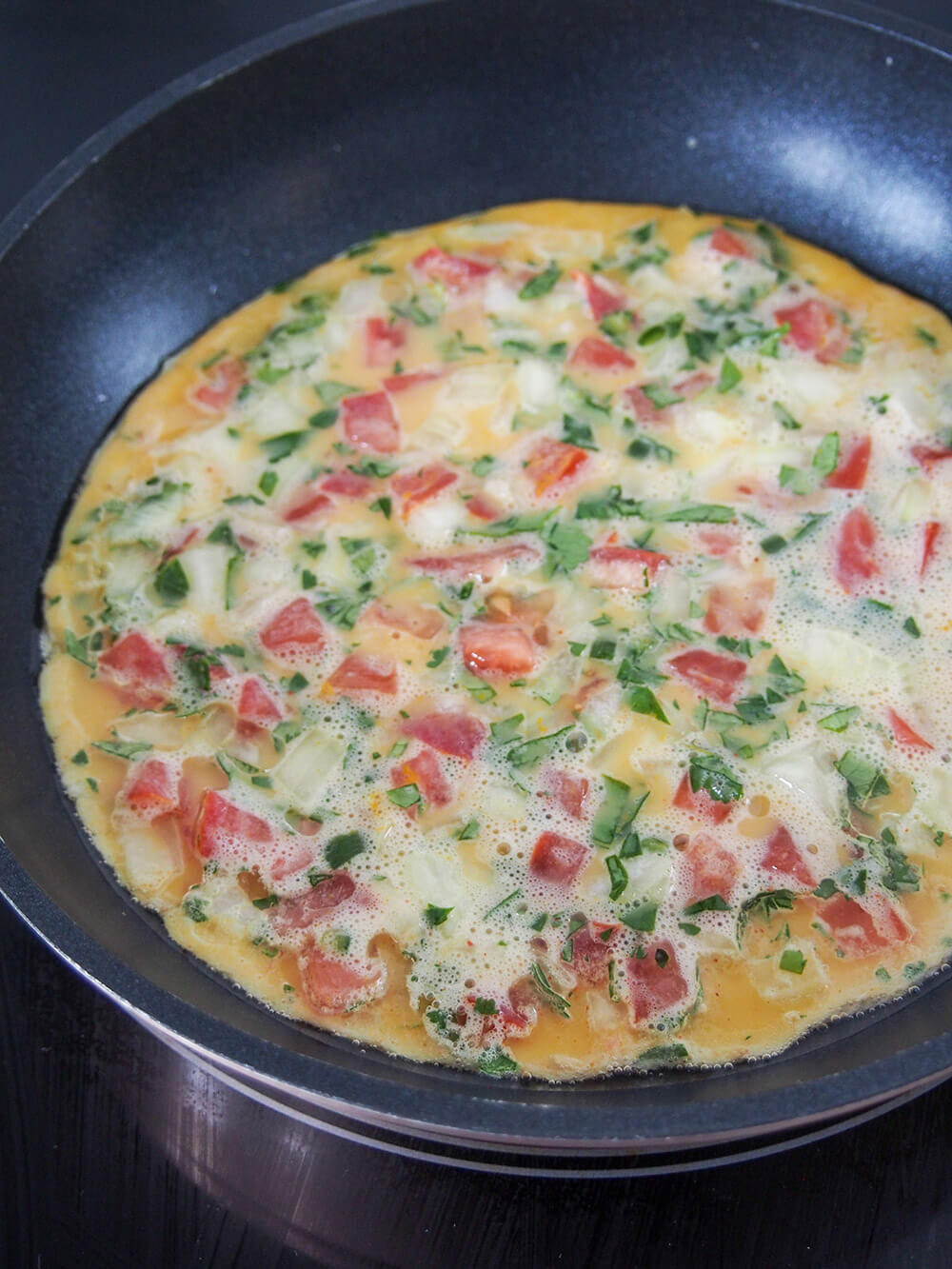 cooking masala omelette cooking omelette on first side