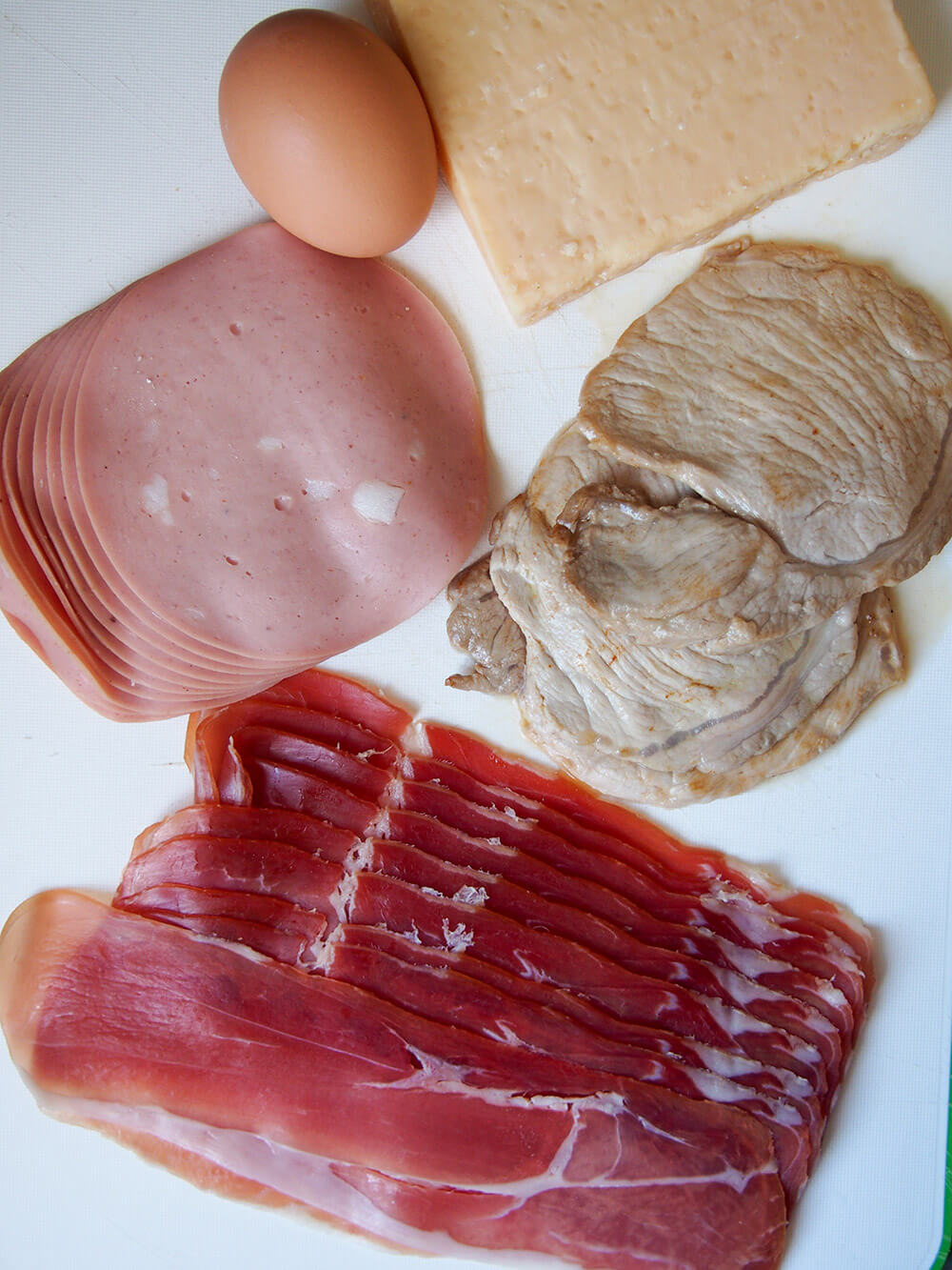 prosciutto, pork, mortadella, egg and parmesan on board to make filling