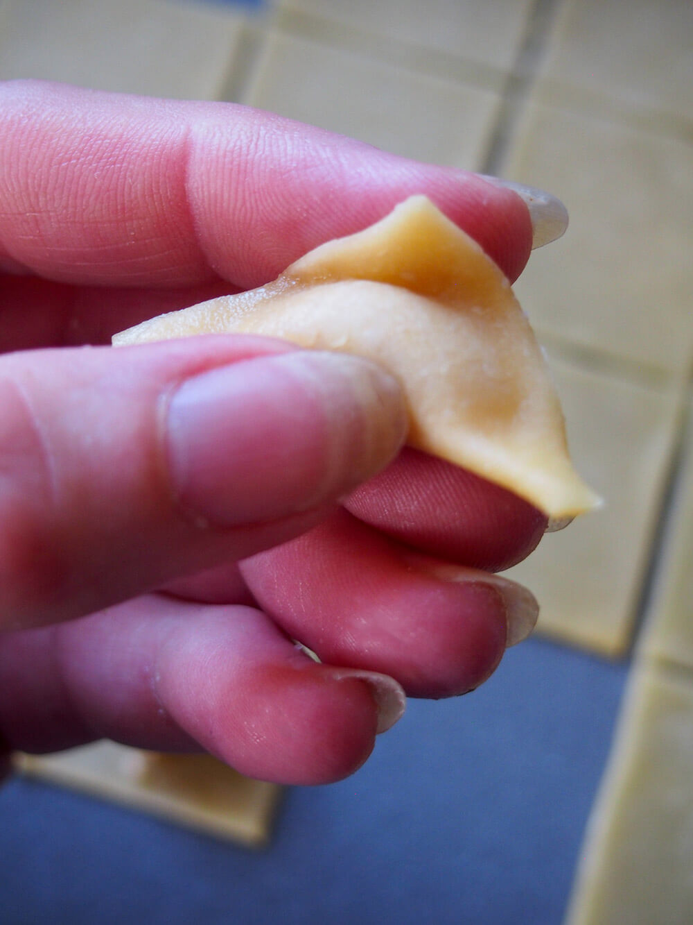 folding tip of tortellini in slightly