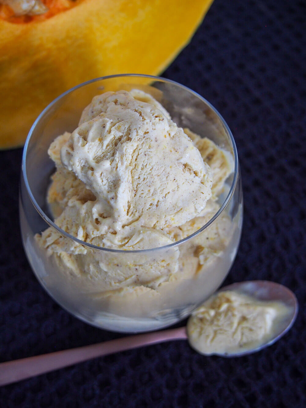 glass of no churn pumpkin ice cream with spoon below