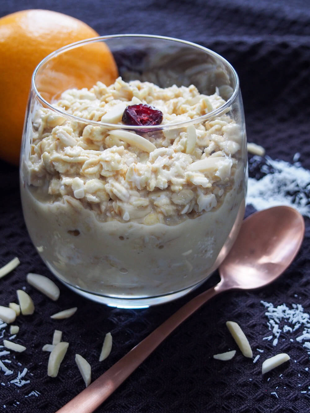 glass of orange overnight oats from side