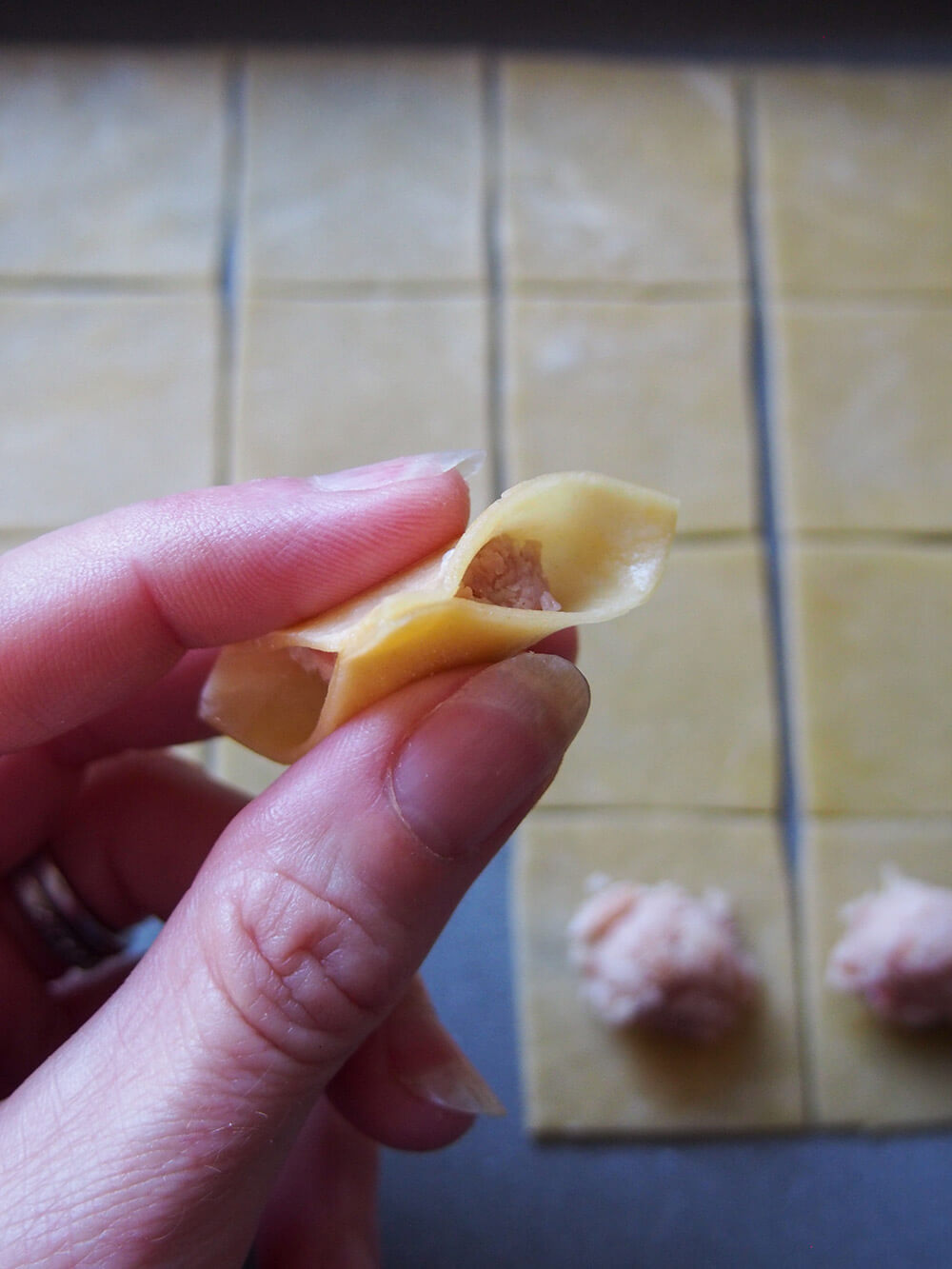 pinched corners of pasta around filling