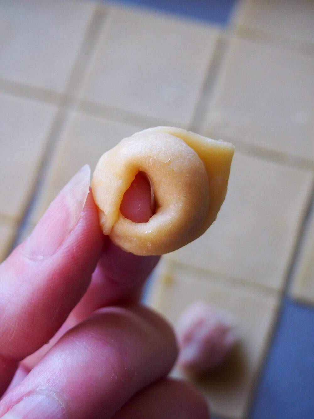 pinching together ends of tortellini