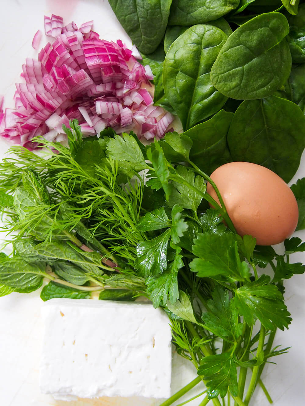 ingredients for filling- spinach, herbs, red onion, egg and feta