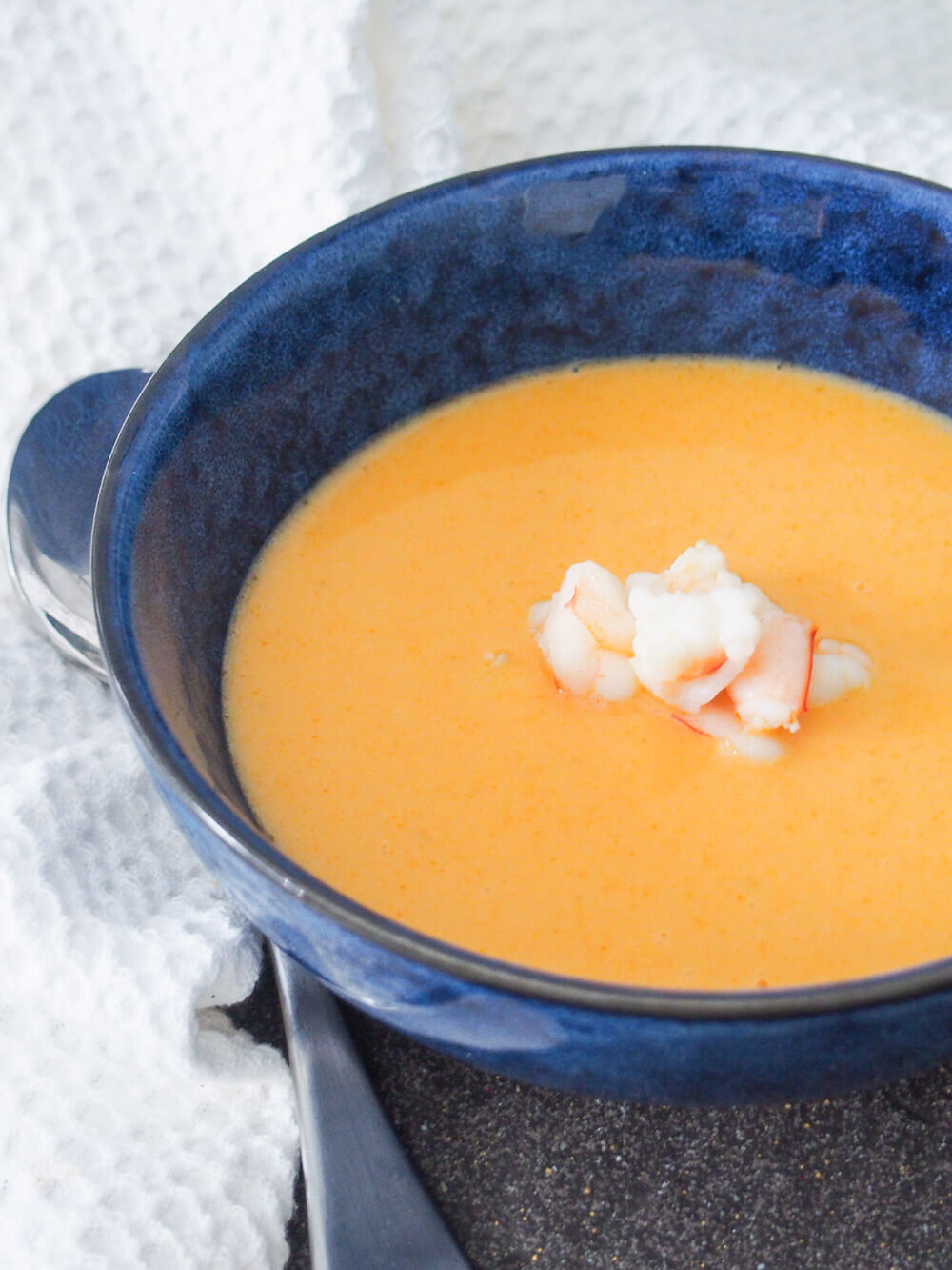 Shrimp bisque is a luscious, smooth and flavorful chowder-like soup. It has an elegant pink color and tastes so good you'll want to serve it for dinner parties and more. bowl of shrimp bisque
