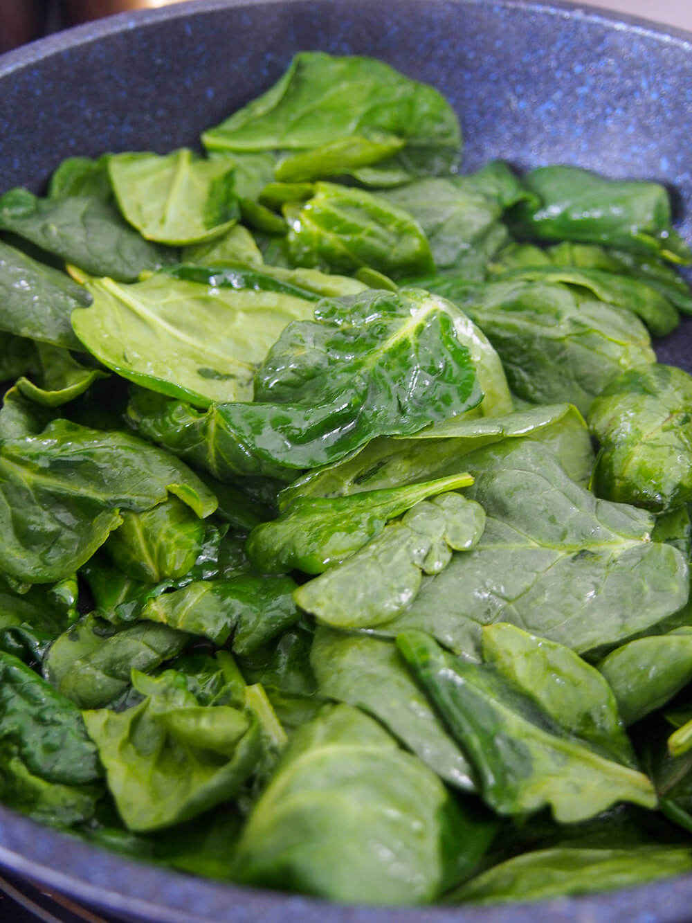 wilting spinach in skillet