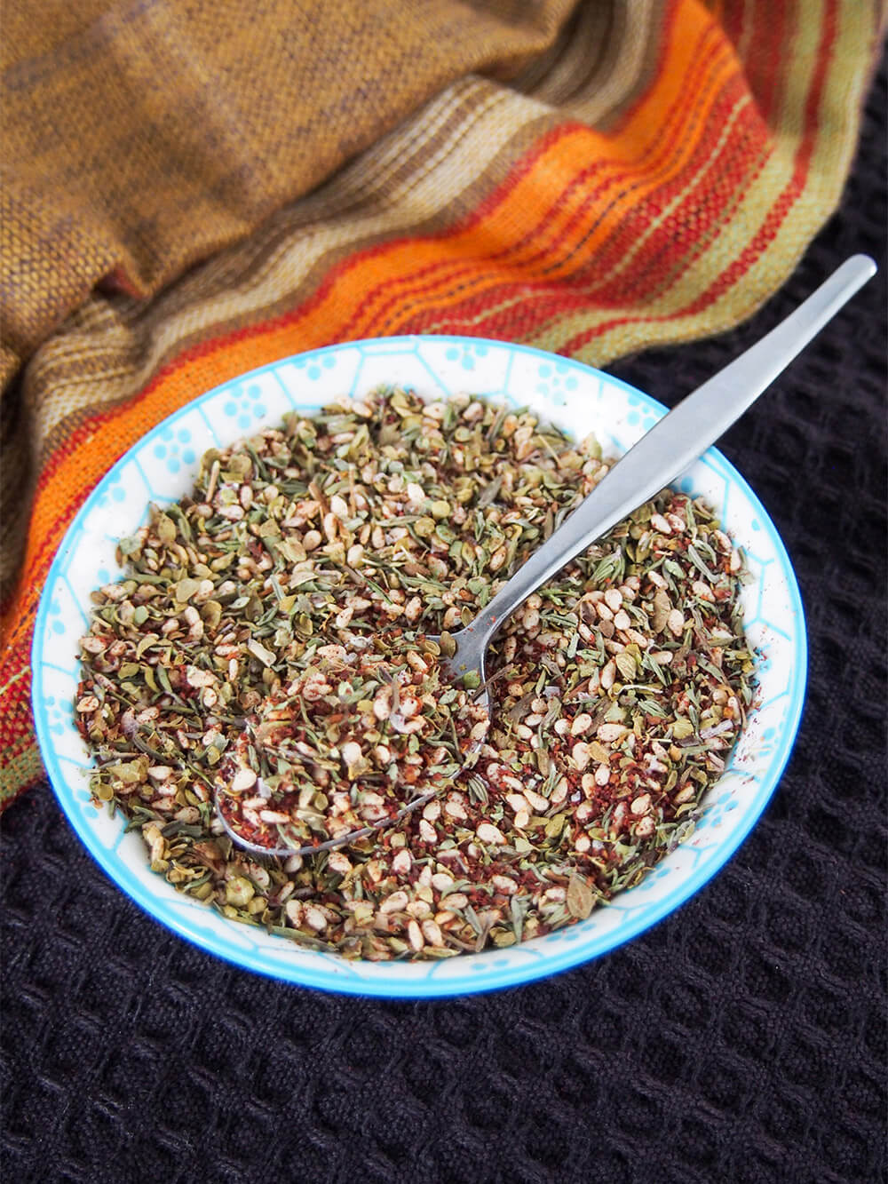 spoon in bowl of za'atar spice blend