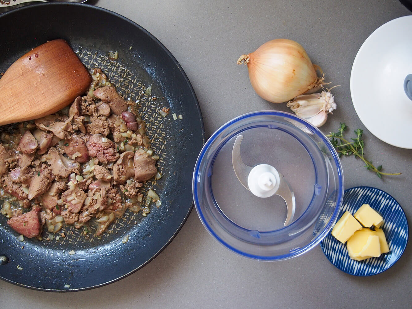 cooked liver and onion next to blender and butter to side
