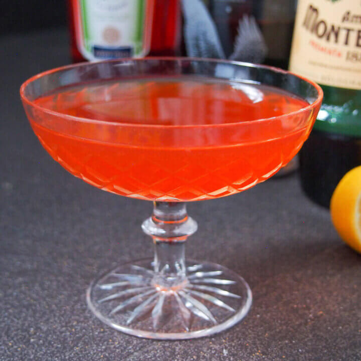 glass filled with paper plane cocktail