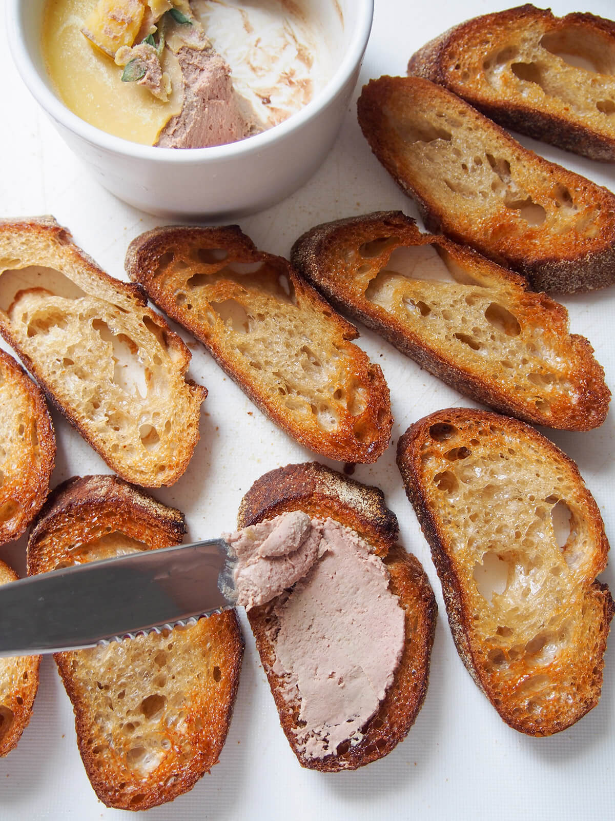 spreading pate on crostini