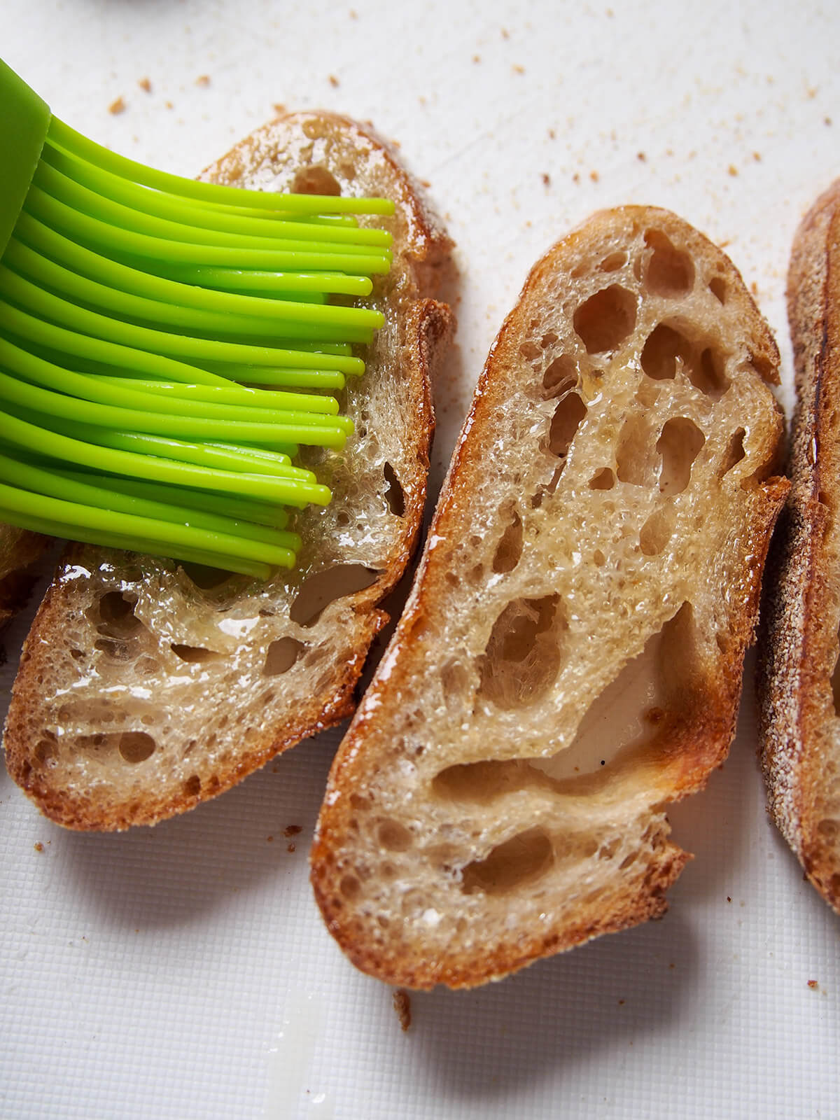 brushing oil on slices of bread