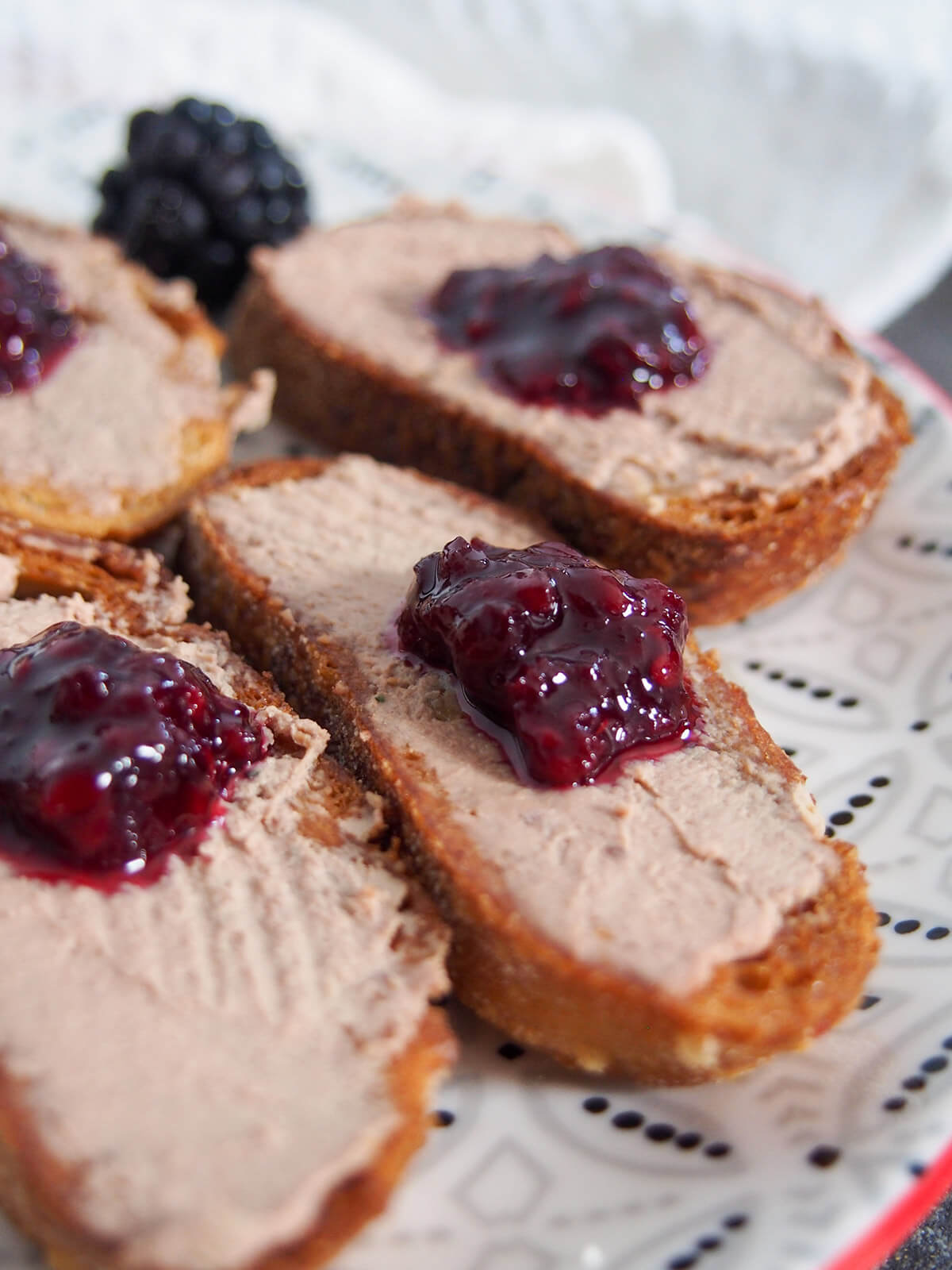 close up of a piece of crostini showing glint on jam