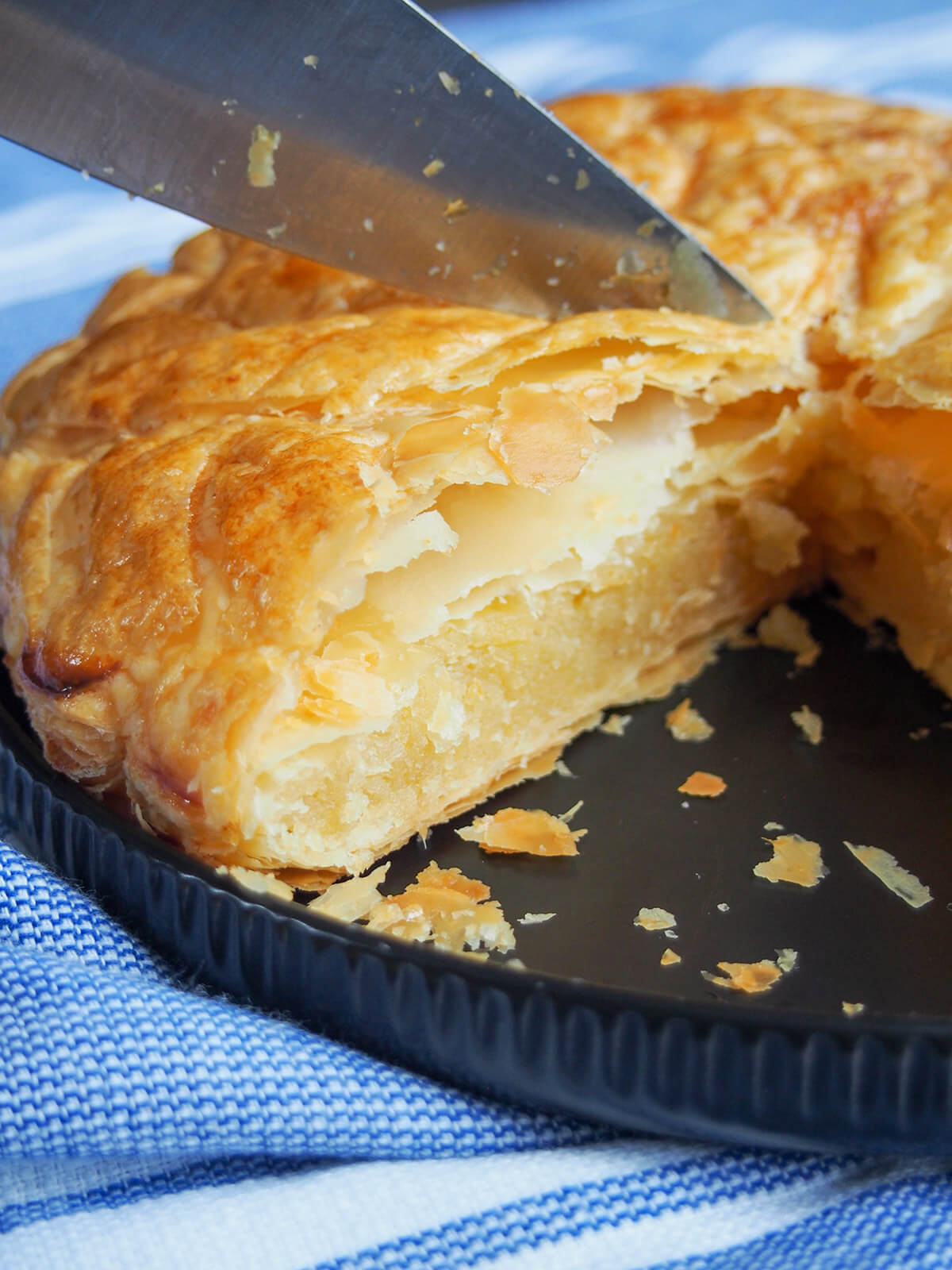 cutting through pastry to cut a slice of tart
