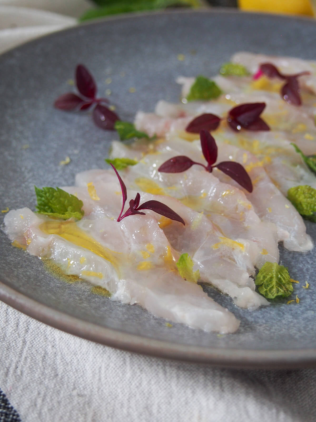 Fish crudo is a simple Italian preparation of raw fish. With only a few ingredients, it takes no time to prepare, but the result is elegant & delicious. close up of finished dish