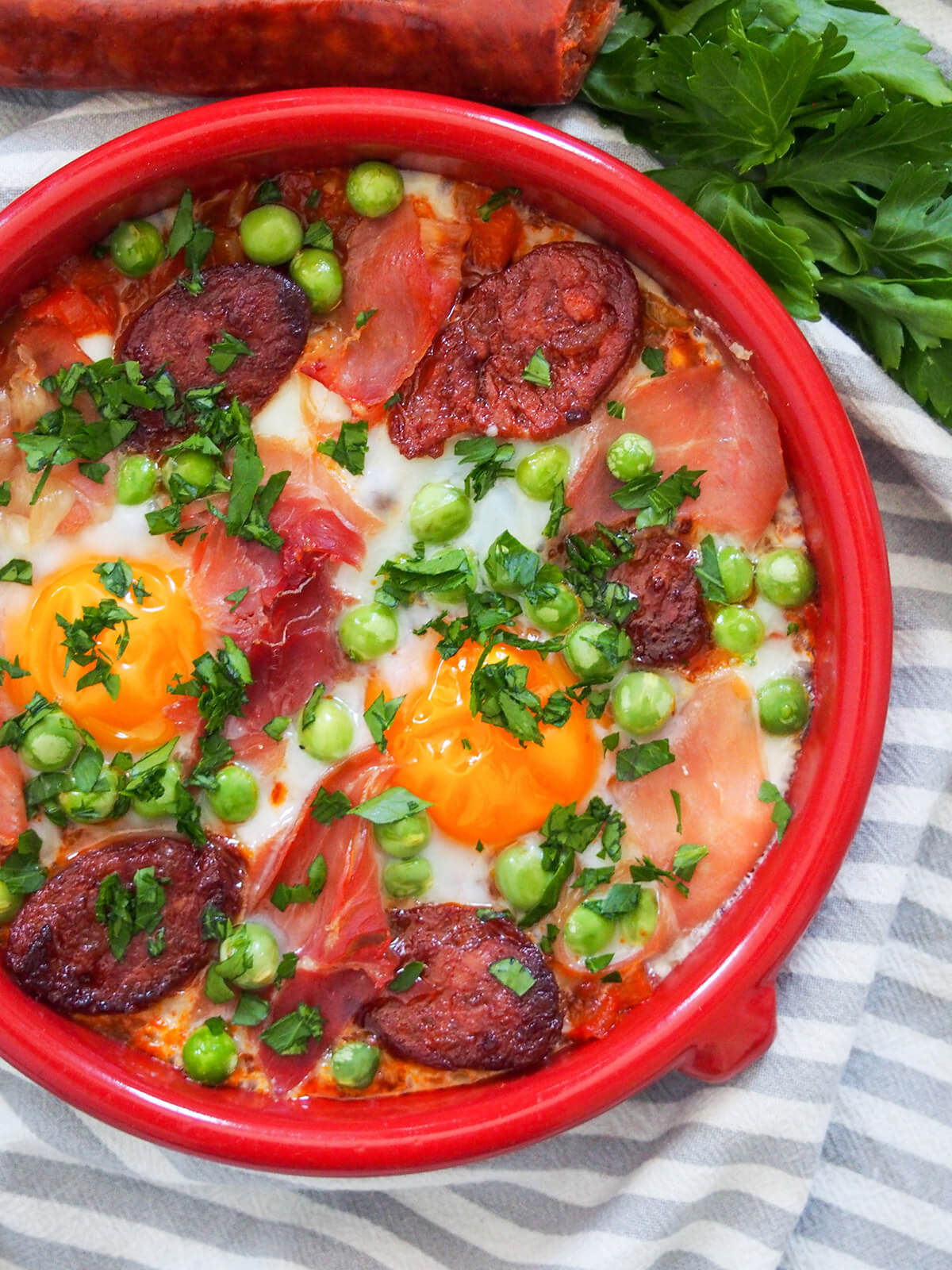 partial view overhead of flamenco eggs in terracotta dish