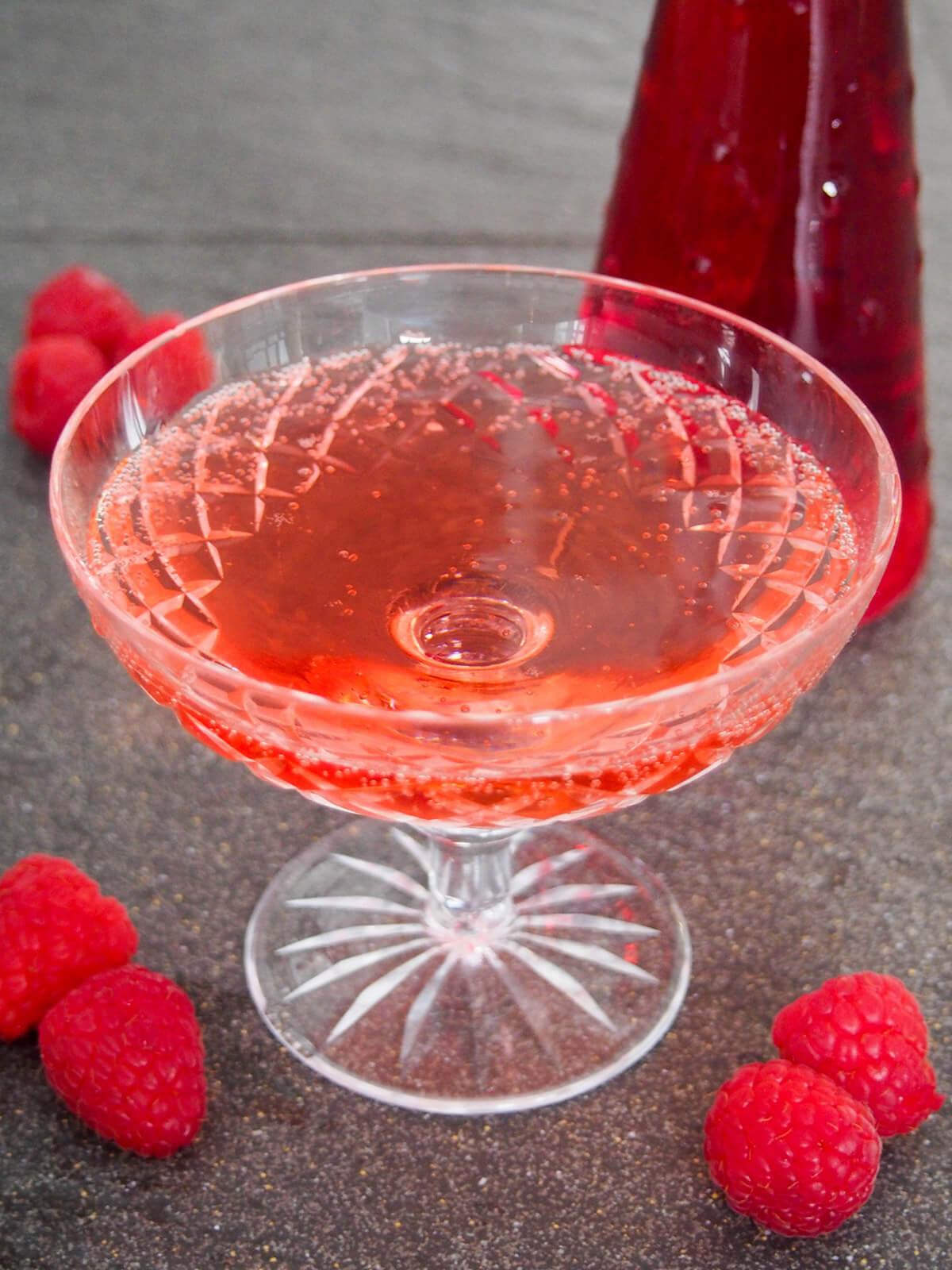 glass of kir imperial raspberry champagne cocktail from overhead