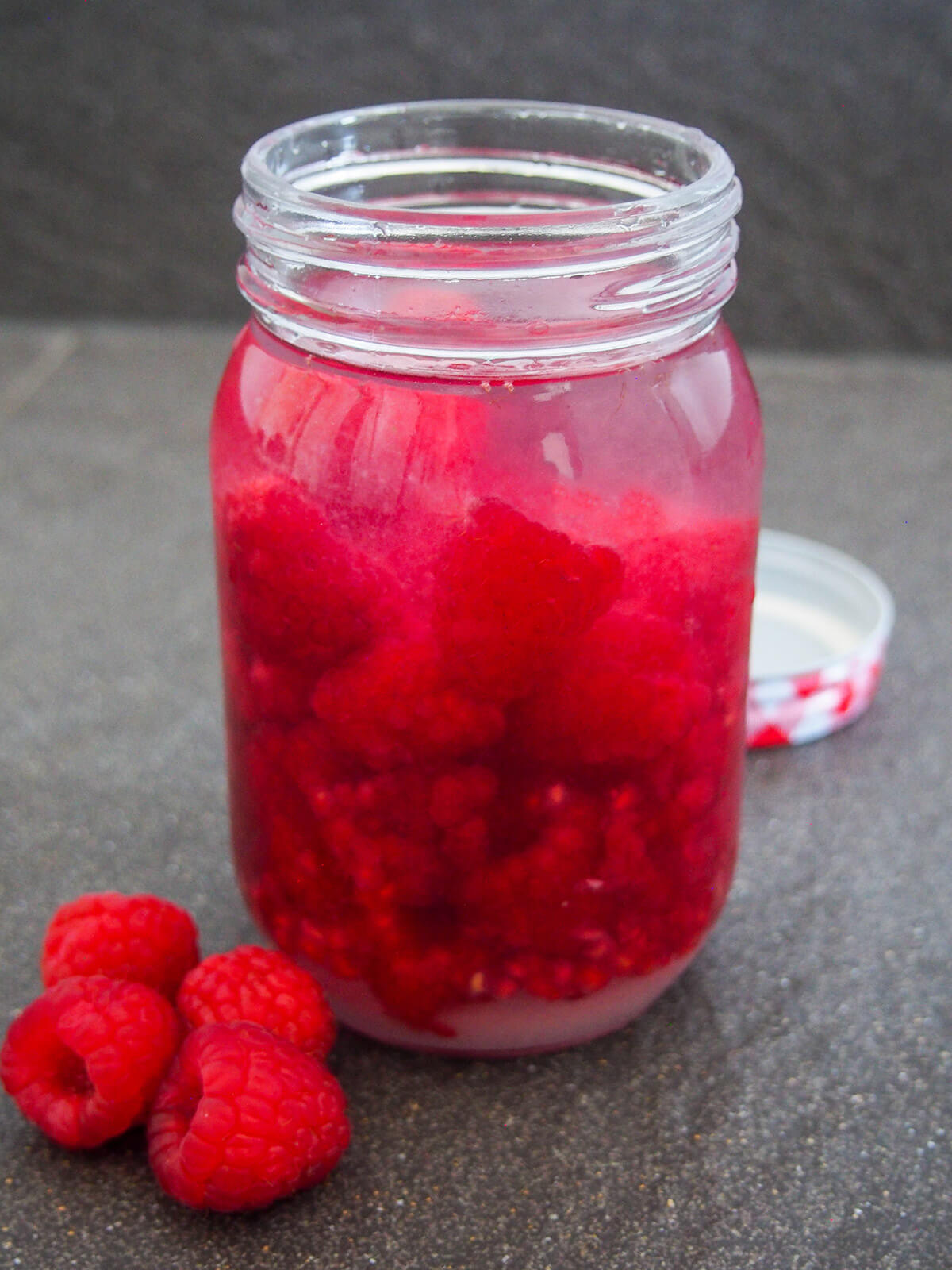 raspberry, sugar and vodka in jar before shaking