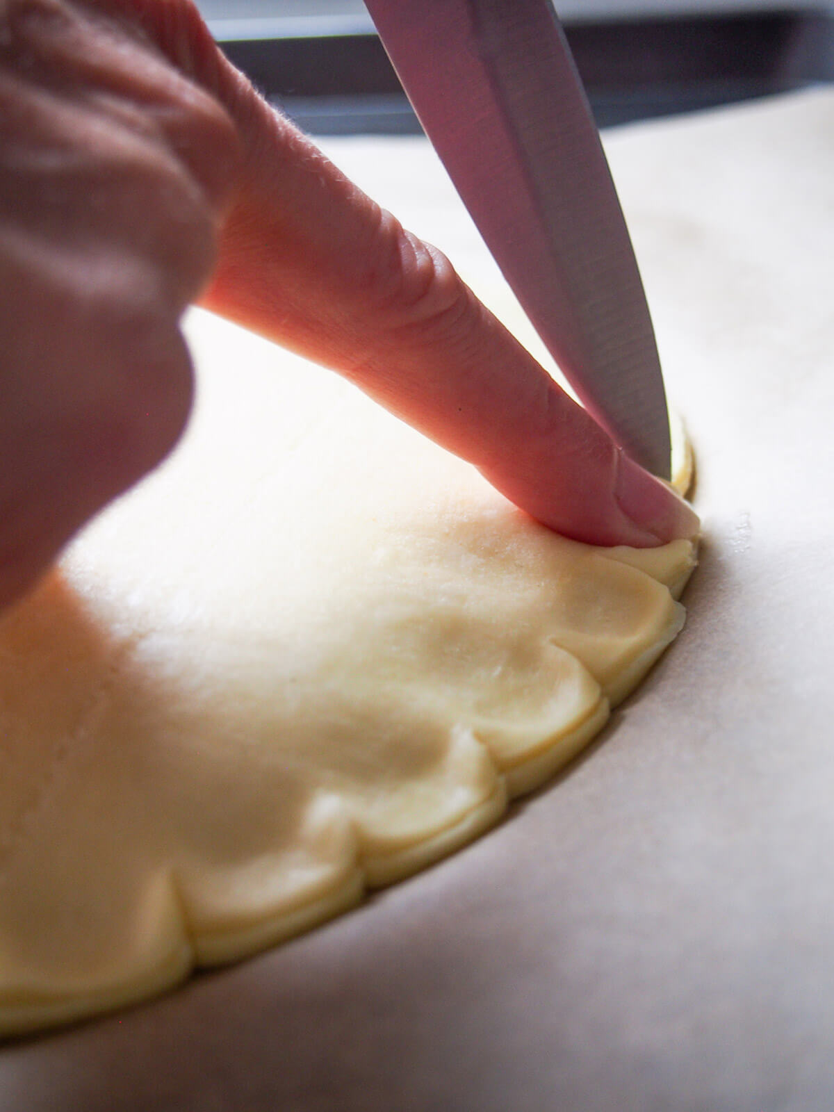 sealing edge of pastry using back of knife
