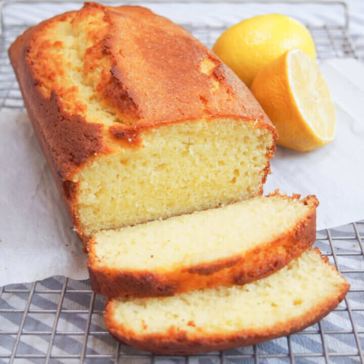 French lemon yogurt cake with slices cut in front of loaf