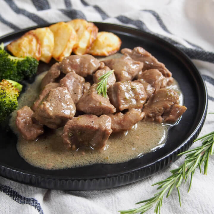 side view of plate of Roman lamb stew, abbacchio alla cacciatora