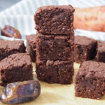 stack of vegan sweet potato brownies pieces with more to side