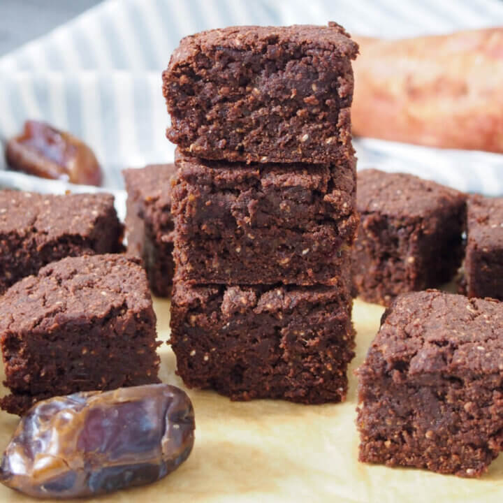 stack of vegan sweet potato brownies pieces with more to side