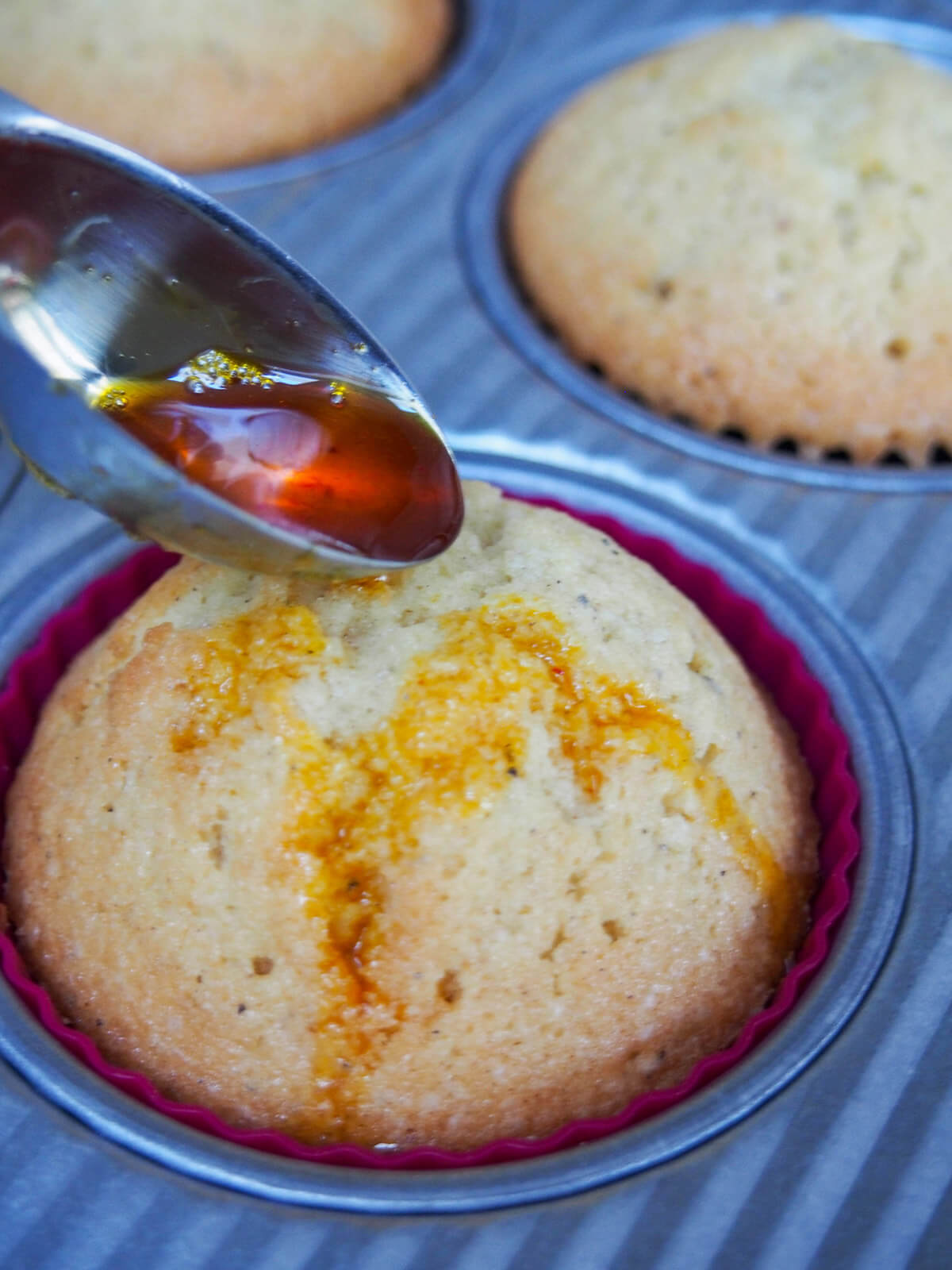 adding saffron drizzle to cupcakes