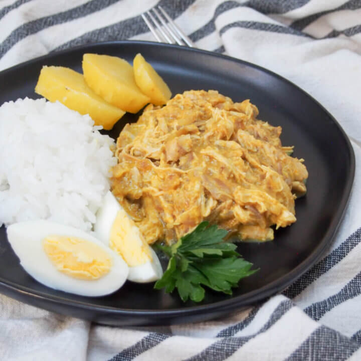 Aji de gallina (Peruvian chicken stew) with rice and potato